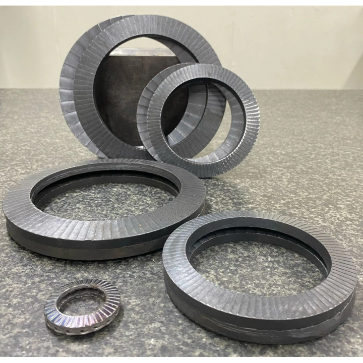 M24 - 25.5x39x(2.5x2) Conical Wedge Lock Washer Pair with larger bolt sizes in background